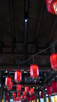 Chinese Red Lanterns Swaying in Traditional Setting