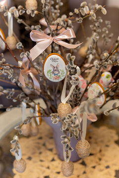 Gingerbread Easter figurines an Easter egg with the words ,Happy Easter, written on it, hanging on a pussy willow branch,