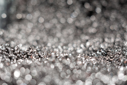 Close-up view of shiny metallic texture with blurred background