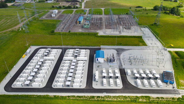 Large scale battery energy storage system connecting to a high voltage electrical substation, representing modern energy infrastructure for grid stability and renewable integration