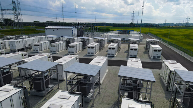 Battery energy storage system with multiple container units and connecting equipment providing electrical power to a high voltage substation and electricity transmission lines