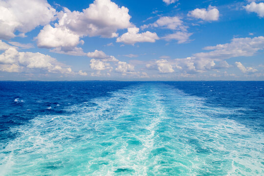 Foam water trail behind the ferry. View from the ship to the sea