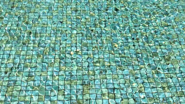 Sunlit Water Ripples over Blue Mosaic Tile Pool Bottom