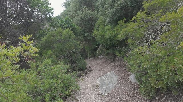 First Person POV Hiking Along Rugged Coastal Cliffs Facing the Mediterranean Sea at Pedra Longa Sardinia
