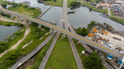 Aerial view of road and pathway in a lush green vegetation environment © Ariyo