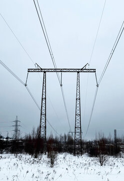 Construction of high voltage pylons in winter. Assembled power transmission line supports, ready for installation.