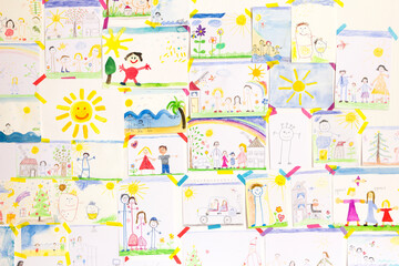Child's drawings hanging on wall