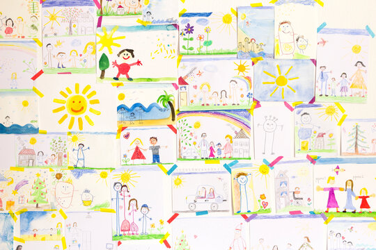Child's drawings hanging on wall