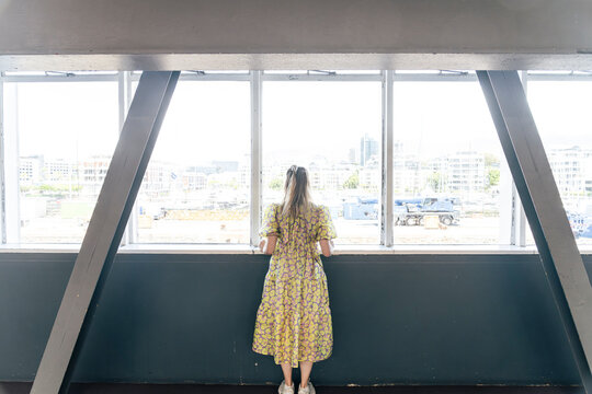 Woman looking out window at V&A Waterfront in Cape Town