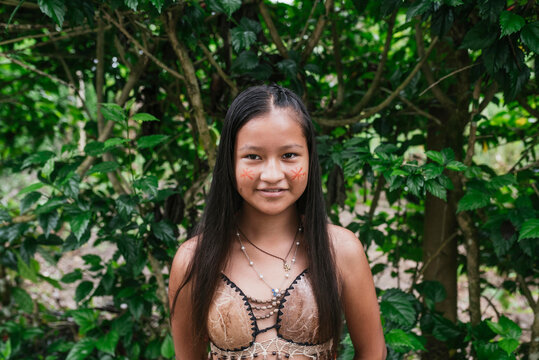Smiling Guarani girl against tree at Misahualli, Ecuador