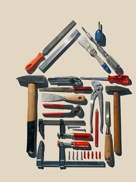 Various hand tools arranged in a house shape with copy space