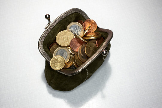 Open retro coin purse full of euro coins for saving and finance
