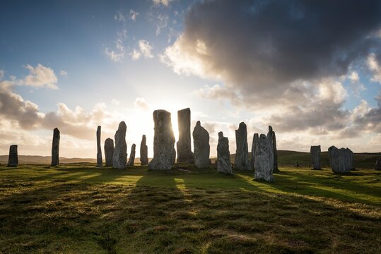 UK, Scotland, Isle of Lewis, Callanish, view to formation of standing stones at backlight