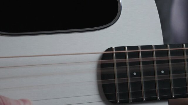 Slow Motion Finger Strumming Acoustic Guitar Strings Close Up