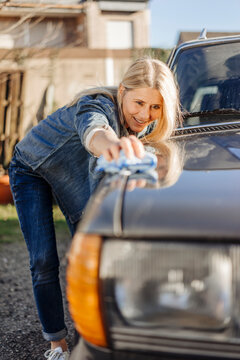 Woman cleaning her car