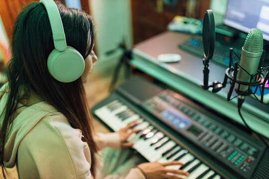 Female musician playing piano in studio
