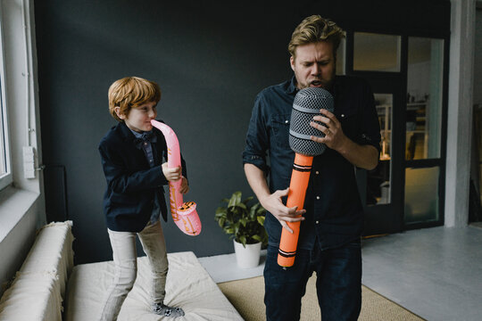 Father and son playing fun instruments
