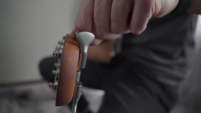 Tuning Acoustic Guitar Close Up with Tuning Pegs