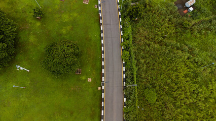Aerial view of road and pathway in a lush green vegetation environment © Ariyo