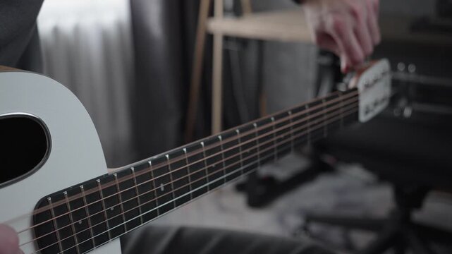 Tuning Acoustic Guitar with Shallow Depth of Field in Home Studio