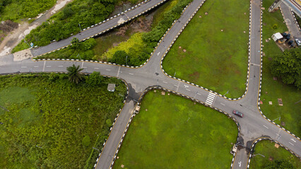 Aerial view of road and pathway in a lush green vegetation environment © Ariyo