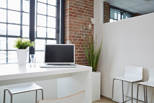 Laptop on desk in modern office