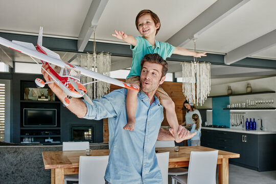 Father and son playing with toy airplane