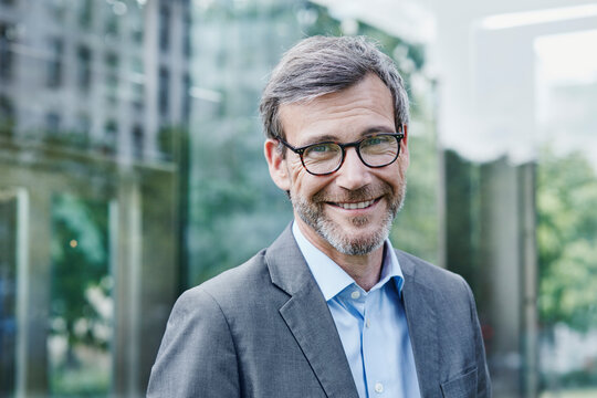 Portrait of smiling mature businessman outdoors