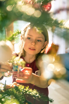 Portrait of girl decorating Christmas tree