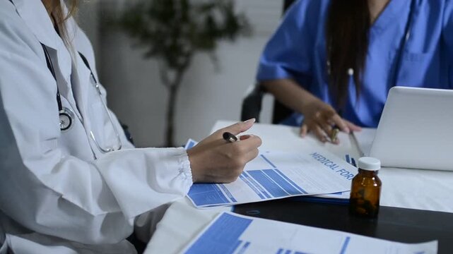 Multiracial doctors team advising about the treatment of patient using x-ray scan during meeting in office clinicMultiracial doctors team 