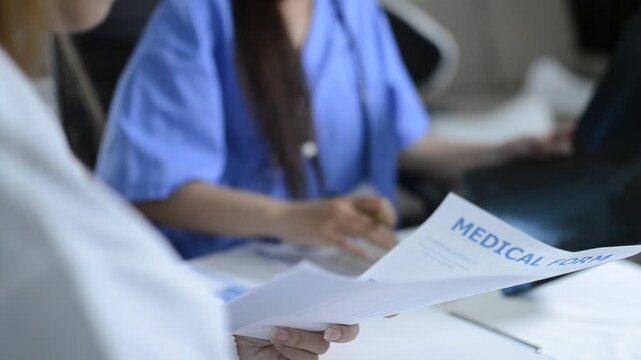 Multiracial doctors team advising about the treatment of patient using x-ray scan during meeting in office clinicMultiracial doctors team 