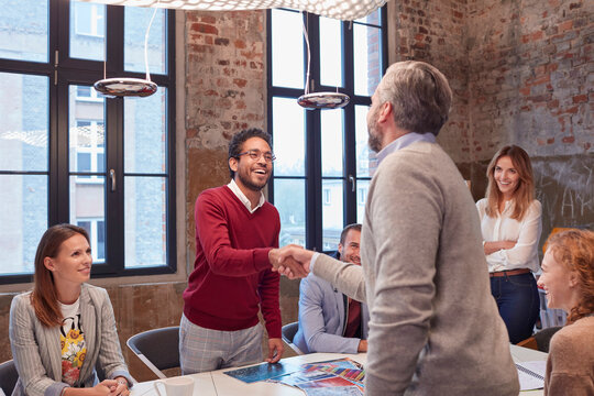 Colleagues greeting at a presentation in the office