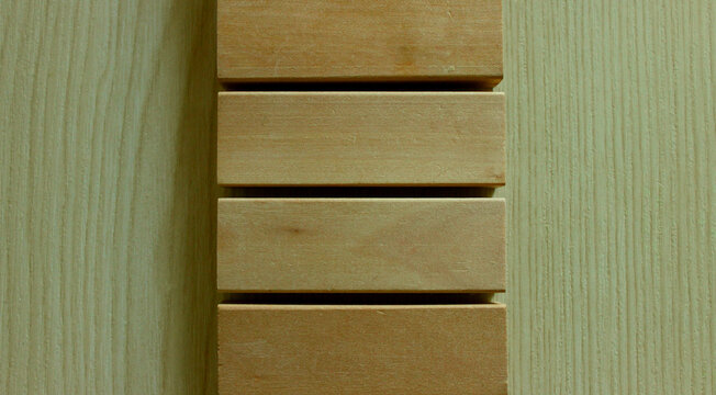 A background of wooden planks lying on a board with a perpendicular pattern
