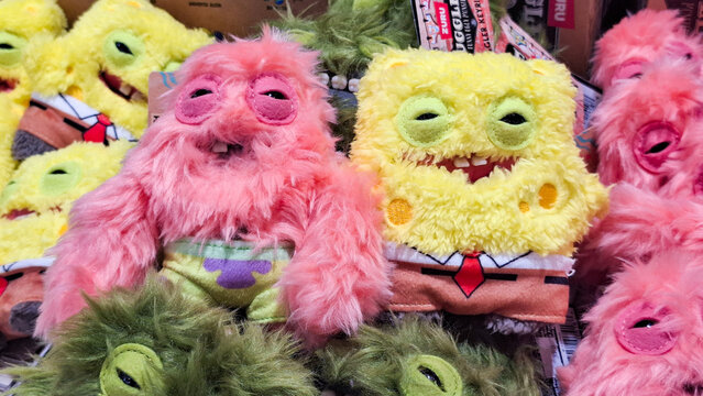 Cute fluffy fuzzy monster and Spongebob Squarepants soft plush toys displayed together in a retail shop for cartoon collectors on June 9, 2026 in Bangkok, Thailand