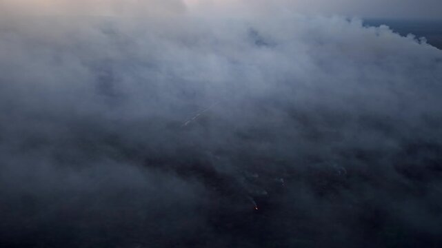 Gray smoke swallows vast sky