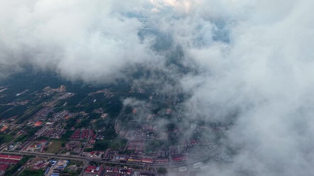 Cirrus clouds drift above urban sprawl