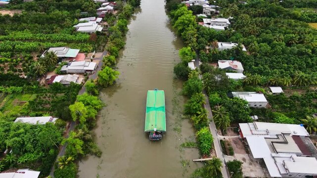 Cargo boat transporting rice husk on a Mekong Delta canal
