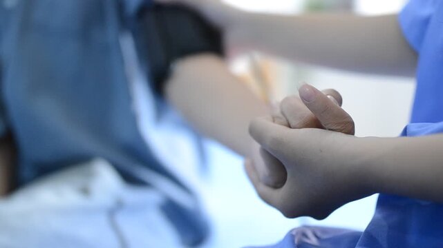 The doctor measures blood pressure to the patient