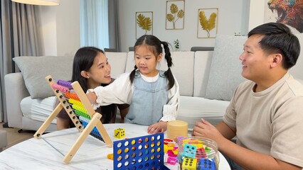 Obraz premium Asian Family Playing with Educational Toys and Abacus in Living Room