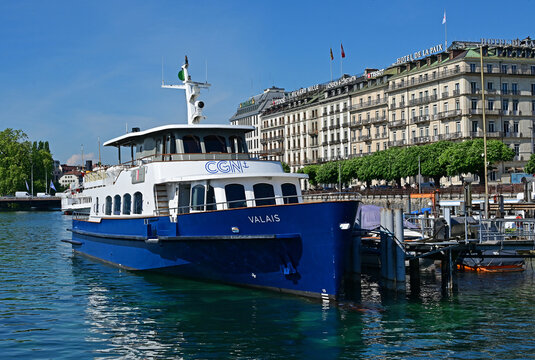 Geneva, Switzerland, Europe - 05.2026 : Logo on cruise ship moored in Mont-Blanc port, fleet of Lake Geneva General Navigation Company - CGN, Lake Geneva, Ritz-Carlton Hotel De la Paix background