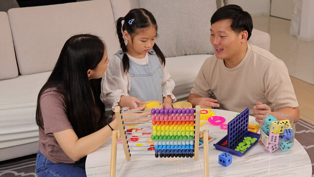 Asian Family Playing with Abacus and Educational Games at Home