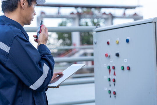 Mechanic or maintenance or electrical engineer checking main electrical control systems industrial plant. Utility fore man daily check power systems in process. Main Distribution Board, Switchboards