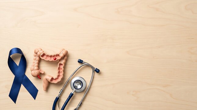 Colorectal cancer awareness ribbon with anatomical intestine model and stethoscope on wood
