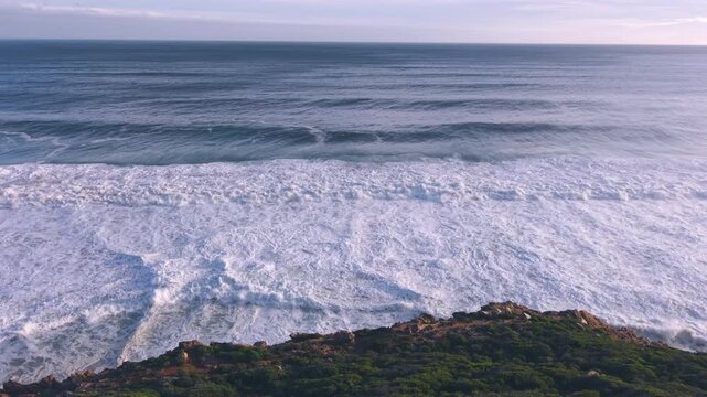 Aerial overhead waves breaking on the coastline