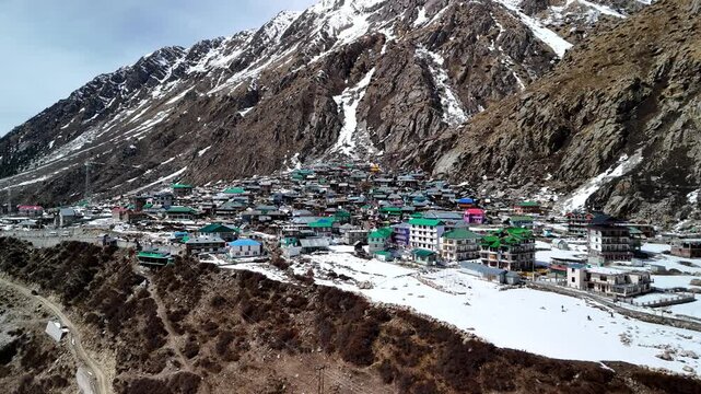 Scenic Aerial View of Chitkul Village Covered in Snow with Himalayan Mountains, Snowy Landscape, Traditional Mountain Homes, Frozen Winter Scenery, Cloudy Sky and Beautiful Kinnaur Valley Nature View