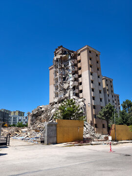 Building collapse near city center during daytime with clear sky and urban surroundings