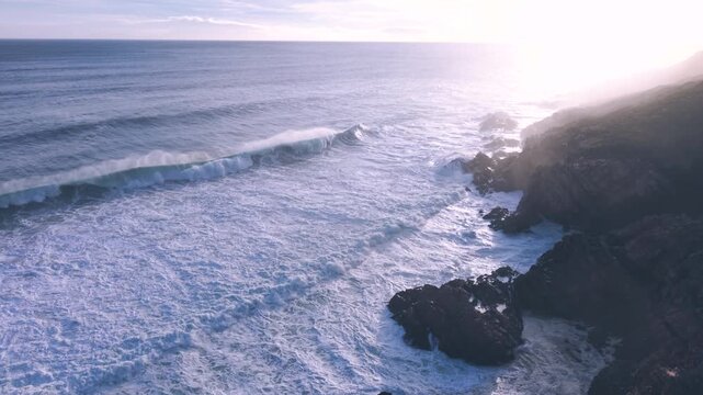 Aerial overhead waves breaking on the coastline