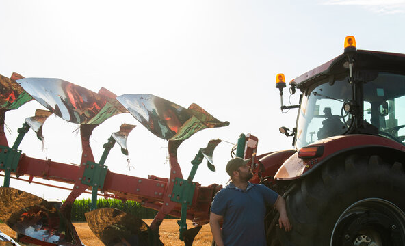 Modern Farmer with Tractor During Evening Farm Work
