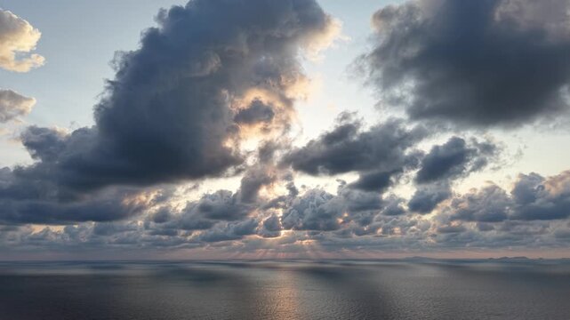Towering clouds fill the sky at sunset
