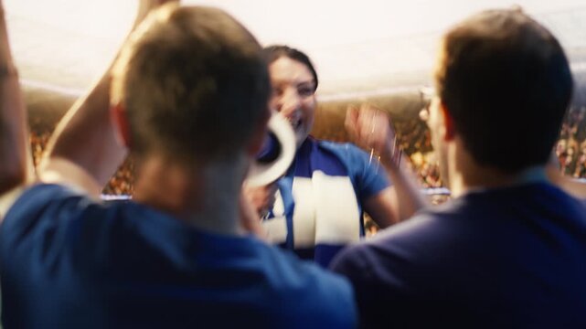 Cheerful woman chanting with megaphone in soccer arena during match day for fan culture, stadium atmosphere and team support content.